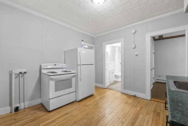 13 Newman St, Lewiston, ME 04240 - kitchen featuring white appliances, light wood-type flooring, baseboard heating, dark countertops, and crown molding