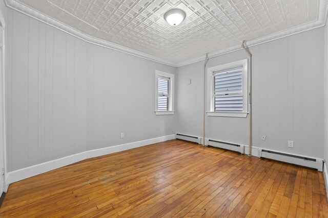 13 Newman St, Lewiston, ME 04240 - empty room featuring an ornate ceiling, hardwood / wood-style floors, and ornamental molding