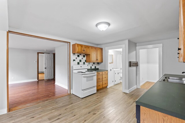 13 Newman St, Lewiston, ME 04240 - kitchen with white electric stove, light wood-style floors, and dark countertops