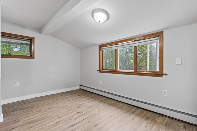 13 Newman St, Lewiston, ME 04240 - empty room featuring a baseboard heating unit, light wood finished floors, and plenty of natural light
