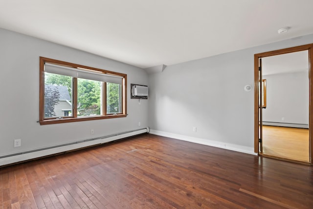 13 Newman St, Lewiston, ME 04240 - spare room featuring a baseboard heating unit, a baseboard radiator, a smoke detector, hardwood / wood-style flooring, and a wall mounted AC