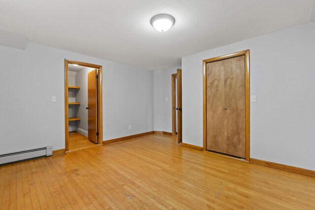 13 Newman St, Lewiston, ME 04240 - empty room with a baseboard radiator and light wood-style floors