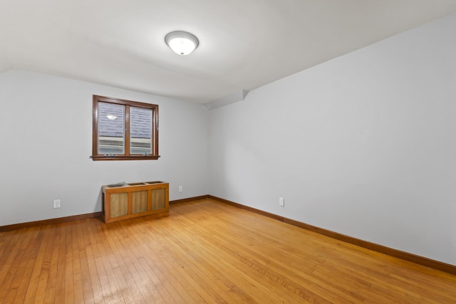 13 Newman St, Lewiston, ME 04240 - empty room with light wood-type flooring and lofted ceiling
