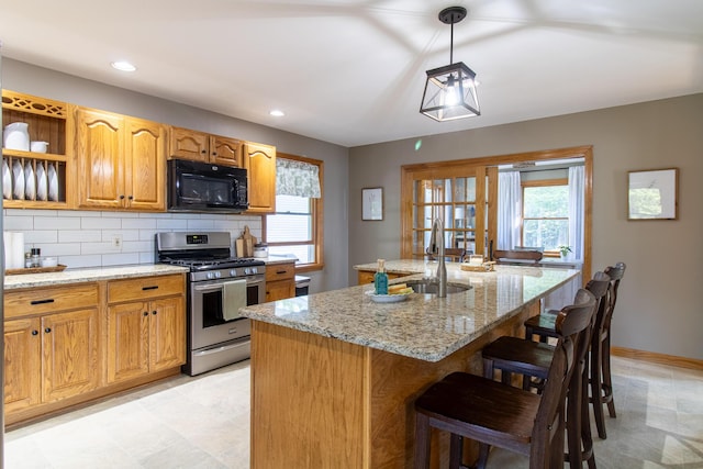 119 Merritt Rd, Steuben, ME 04680 - kitchen featuring black microwave, gas stove, light stone counters, tasteful backsplash, and a kitchen bar