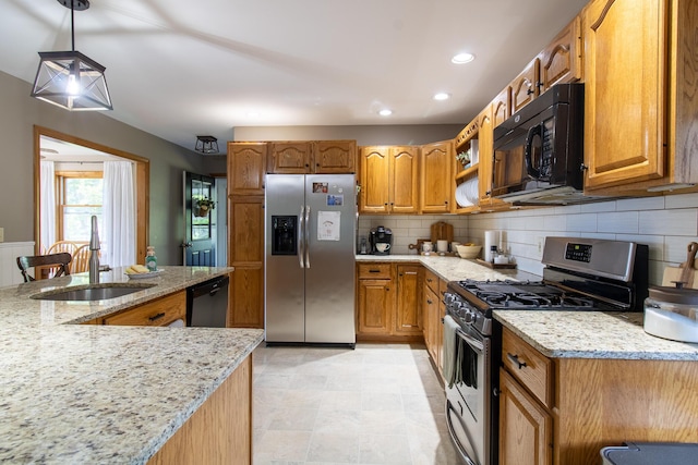 119 Merritt Rd, Steuben, ME 04680 - kitchen with stainless steel appliances, light stone countertops, tasteful backsplash, brown cabinetry, and recessed lighting