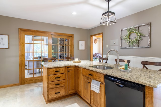 119 Merritt Rd, Steuben, ME 04680 - kitchen with dishwasher, light stone counters, pendant lighting, and brown cabinetry