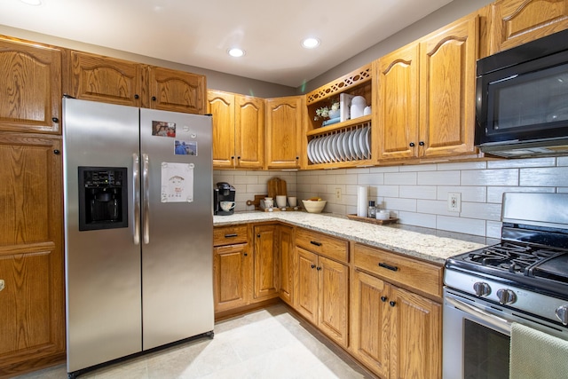 119 Merritt Rd, Steuben, ME 04680 - kitchen featuring stainless steel appliances, light stone counters, backsplash, recessed lighting, and open shelves