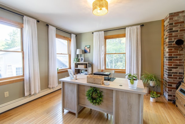 119 Merritt Rd, Steuben, ME 04680 - office area featuring a baseboard heating unit and light wood-style floors