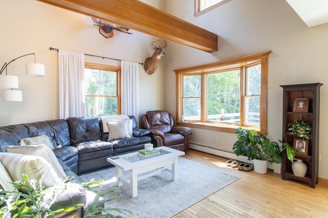 119 Merritt Rd, Steuben, ME 04680 - living area with healthy amount of natural light, hardwood / wood-style flooring, lofted ceiling, and a baseboard radiator