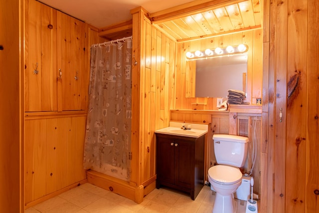119 Merritt Rd, Steuben, ME 04680 - full bathroom featuring vanity, a shower with shower curtain, wooden walls, and tile patterned floors