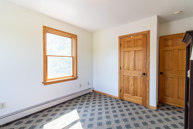 119 Merritt Rd, Steuben, ME 04680 - unfurnished bedroom with a baseboard radiator and dark carpet