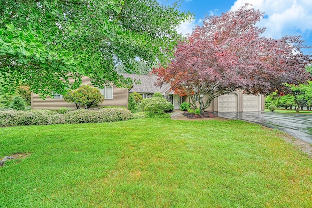 3 Tallwood Rd, Augusta, ME 04330 - view of front of home with asphalt driveway, a front yard, and a garage
