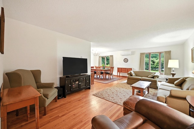 3 Tallwood Rd, Augusta, ME 04330 - living area with a wall unit AC, a chandelier, and light wood finished floors