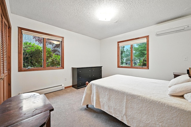 3 Tallwood Rd, Augusta, ME 04330 - bedroom with a wall unit AC, baseboard heating, multiple windows, carpet, and a textured ceiling