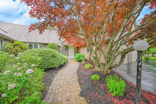 3 Tallwood Rd, Augusta, ME 04330 - view of front of property featuring roof with shingles, stone siding, and a garage