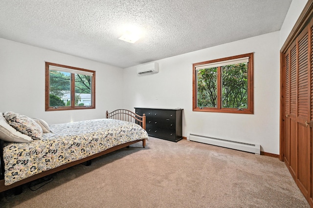 3 Tallwood Rd, Augusta, ME 04330 - bedroom featuring a baseboard heating unit, a wall mounted air conditioner, carpet, a closet, and a textured ceiling
