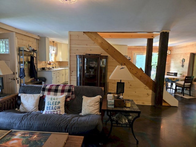 340 Campground Rd, Anson, ME 04958 - living area with wood walls and finished concrete flooring