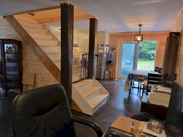 340 Campground Rd, Anson, ME 04958 - living room with wooden walls, concrete flooring, and stairway