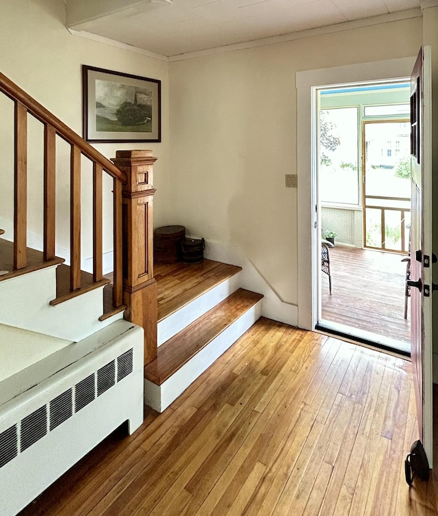 72 Federal Rd, Parsonsfield, ME 04047 - foyer entrance featuring radiator, hardwood / wood-style flooring, ornamental molding, and stairway