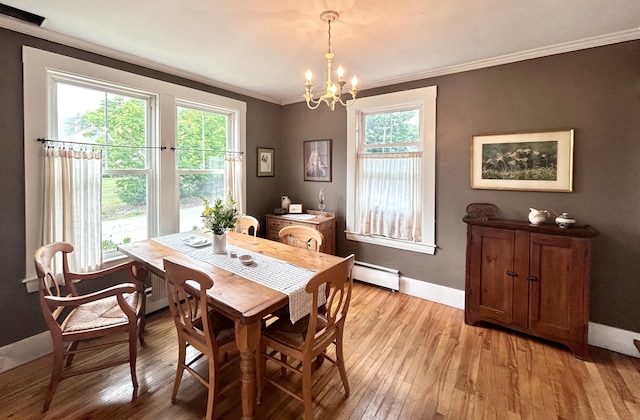 72 Federal Rd, Parsonsfield, ME 04047 - dining area with ornamental molding, light wood-style floors, a chandelier, and a baseboard heating unit