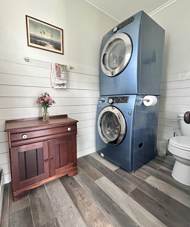 72 Federal Rd, Parsonsfield, ME 04047 - laundry room featuring stacked washing machine and dryer, dark wood finished floors, ornamental molding, and wooden walls