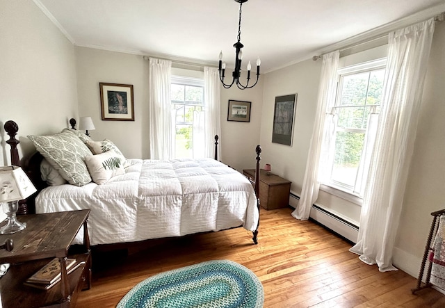 72 Federal Rd, Parsonsfield, ME 04047 - bedroom featuring light wood-style floors, a chandelier, crown molding, and baseboard heating