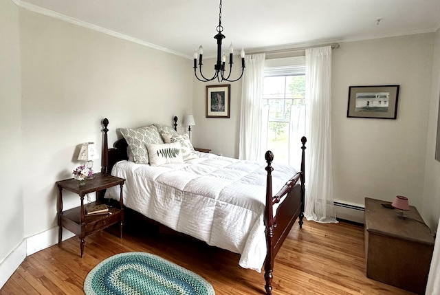 72 Federal Rd, Parsonsfield, ME 04047 - bedroom with baseboard heating, crown molding, a chandelier, and wood finished floors