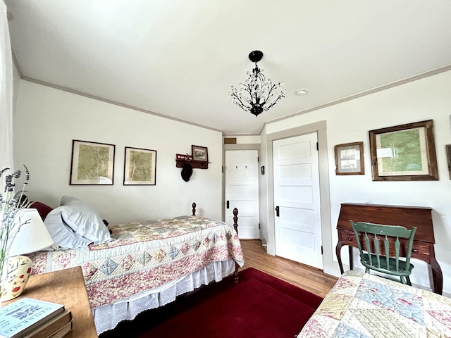 72 Federal Rd, Parsonsfield, ME 04047 - bedroom featuring dark wood-type flooring, crown molding, and a chandelier