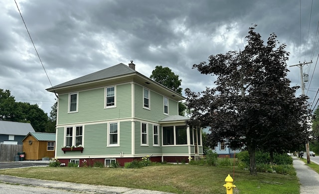 72 Federal Rd, Parsonsfield, ME 04047 - view of property exterior with a chimney, a sunroom, and a lawn