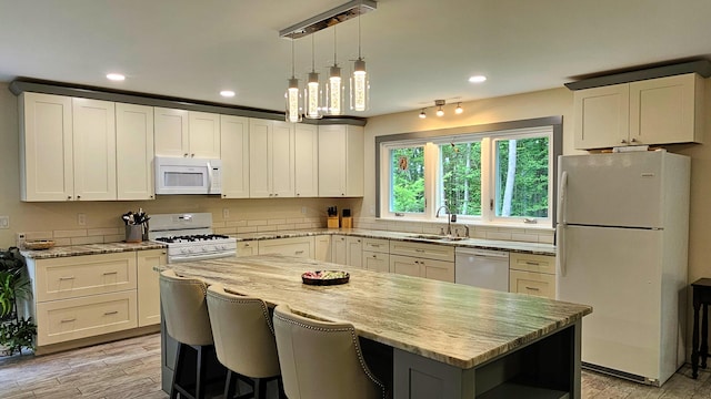 62 Cobb Rd, Stetson, ME 04488 - kitchen with white appliances, light stone counters, a center island, recessed lighting, and backsplash