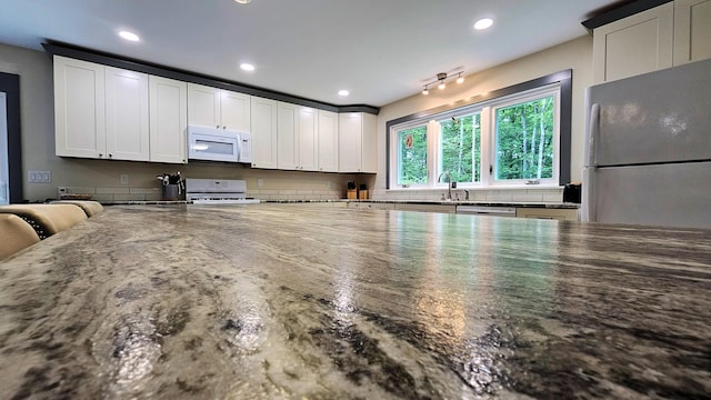 62 Cobb Rd, Stetson, ME 04488 - kitchen with white microwave, freestanding refrigerator, range, white cabinetry, and recessed lighting