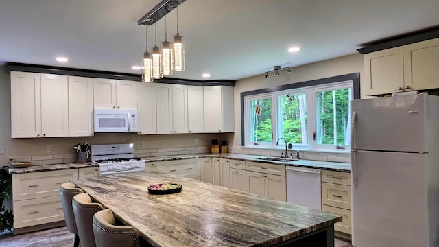 62 Cobb Rd, Stetson, ME 04488 - kitchen featuring white appliances, a kitchen island, recessed lighting, light stone counters, and white cabinetry