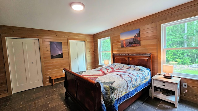 62 Cobb Rd, Stetson, ME 04488 - bedroom featuring wooden walls and dark tile patterned flooring