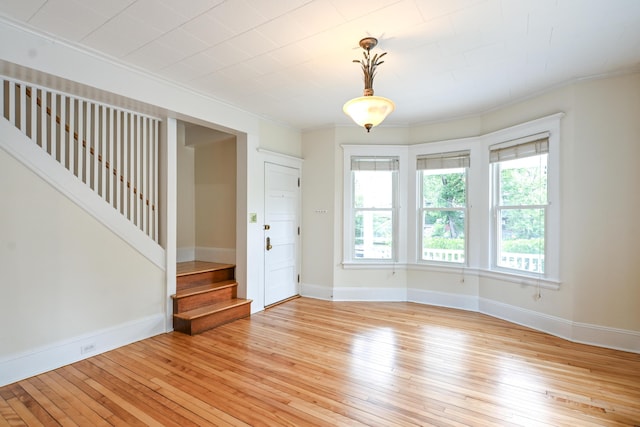 18 Colonial Rd Unit 18, Portland, ME 04102 - unfurnished room featuring stairs, light wood-style flooring, and crown molding