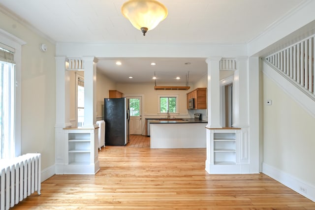 18 Colonial Rd Unit 18, Portland, ME 04102 - kitchen featuring radiator heating unit, decorative columns, refrigerator with ice dispenser, light wood-style flooring, and ornamental molding