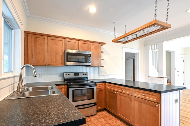 18 Colonial Rd Unit 18, Portland, ME 04102 - kitchen featuring appliances with stainless steel finishes, a peninsula, crown molding, dark countertops, and brown cabinets