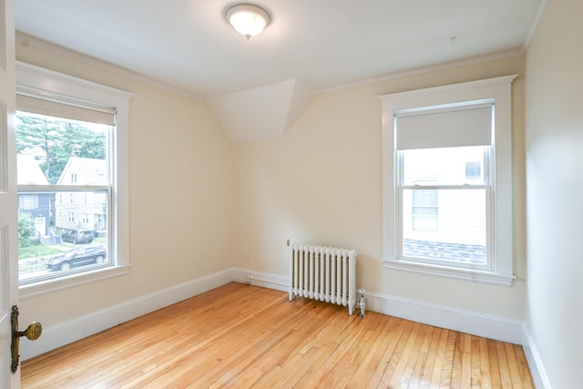 18 Colonial Rd Unit 18, Portland, ME 04102 - additional living space with radiator, hardwood / wood-style flooring, and vaulted ceiling