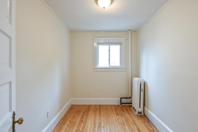 18 Colonial Rd Unit 18, Portland, ME 04102 - empty room featuring radiator heating unit, light wood-style floors, and crown molding