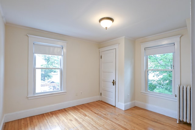 18 Colonial Rd Unit 18, Portland, ME 04102 - spare room featuring radiator, light wood-style floors, and crown molding