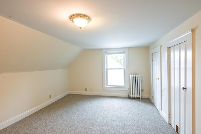 18 Colonial Rd Unit 18, Portland, ME 04102 - additional living space with radiator heating unit, carpet floors, and vaulted ceiling