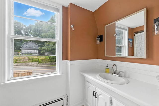 214 S Main St, Auburn, ME 04210 - full bath featuring vanity, baseboard heating, and a wainscoted wall