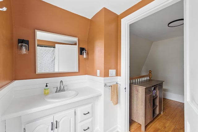 214 S Main St, Auburn, ME 04210 - full bathroom featuring vanity, wood finished floors, and lofted ceiling