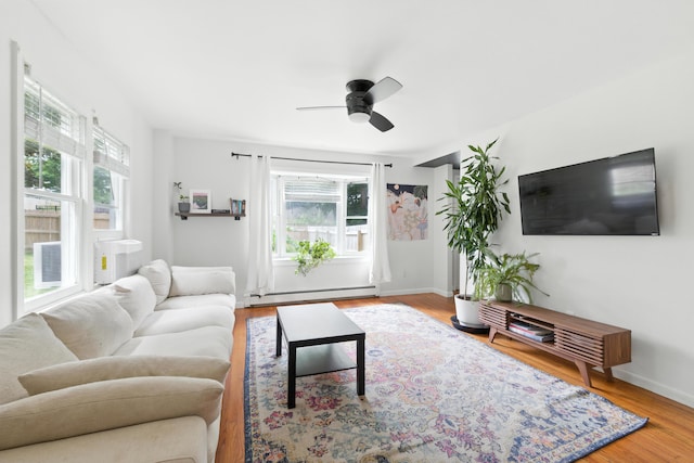 214 S Main St, Auburn, ME 04210 - living area with baseboard heating, a ceiling fan, and wood finished floors