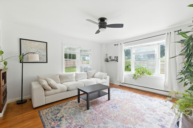 214 S Main St, Auburn, ME 04210 - living area featuring baseboard heating, a ceiling fan, and wood finished floors