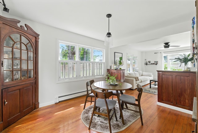 214 S Main St, Auburn, ME 04210 - dining area with baseboard heating, light wood-type flooring, and healthy amount of natural light