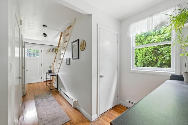 214 S Main St, Auburn, ME 04210 - hallway featuring baseboard heating, light wood-style floors, and stairs