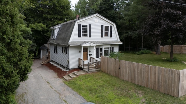 214 S Main St, Auburn, ME 04210 - dutch colonial with driveway, a gambrel roof, a shingled roof, and an outbuilding