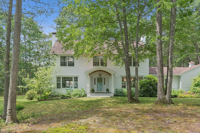 6 Beechwood Ln, Falmouth, ME 04105 - colonial inspired home featuring a front lawn and a chimney