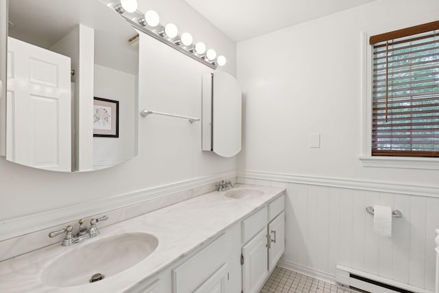 6 Beechwood Ln, Falmouth, ME 04105 - full bath featuring a baseboard heating unit, double vanity, plenty of natural light, a wainscoted wall, and tile patterned flooring