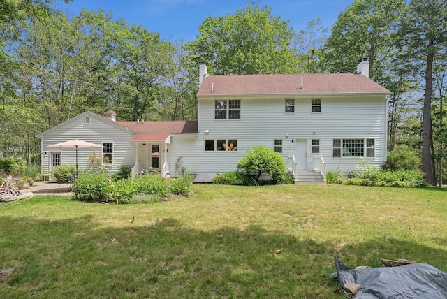 6 Beechwood Ln, Falmouth, ME 04105 - back of property featuring a chimney and a lawn